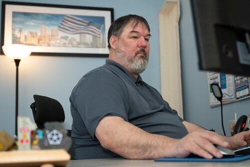 Image of person working at his desk