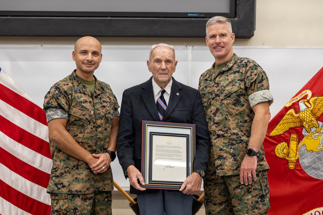Retired U.S. Marine Corps Chief Warrant Officer 4 Gilbert H. Bolton, center, a Marine gunner, poses for a photo with Sgt. Maj. Damian G. Rodriguez, left, the sergeant major, and Col. Patrick B. Byrne, the Commanding Officer, both of School of Infantry-West, during an award ceremony at SOI-West, Marine Corps Base Camp Pendleton, California, Aug. 22, 2024.  Bolton received a Presidential Lifetime Achievement Award for completing over 4,000 hours of service in his community.  Bolton retired on the first of October in 1991 after 32 years of honorable service. (U.S. Marine Corps photo by Lance Cpl. Mhecaela J. Watts)