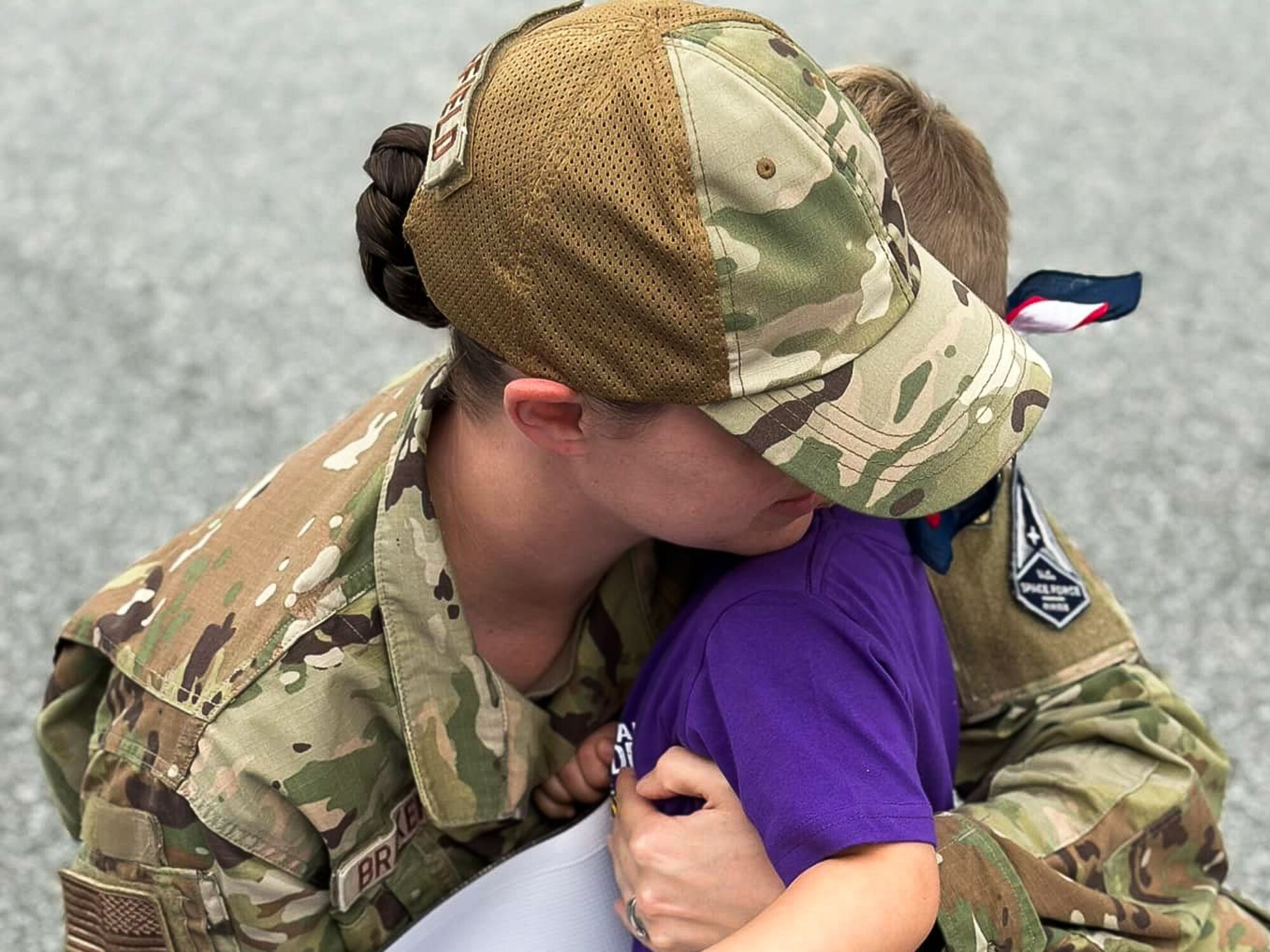 U.S. Air Force Tech Sgt. Renna Brakefield, Headquarters Air Force, Air Force Judge Advocate General's School paralegal instructor embraces her son Harrison, at Robins Air Force Base, Georgia, May 15 2023.
