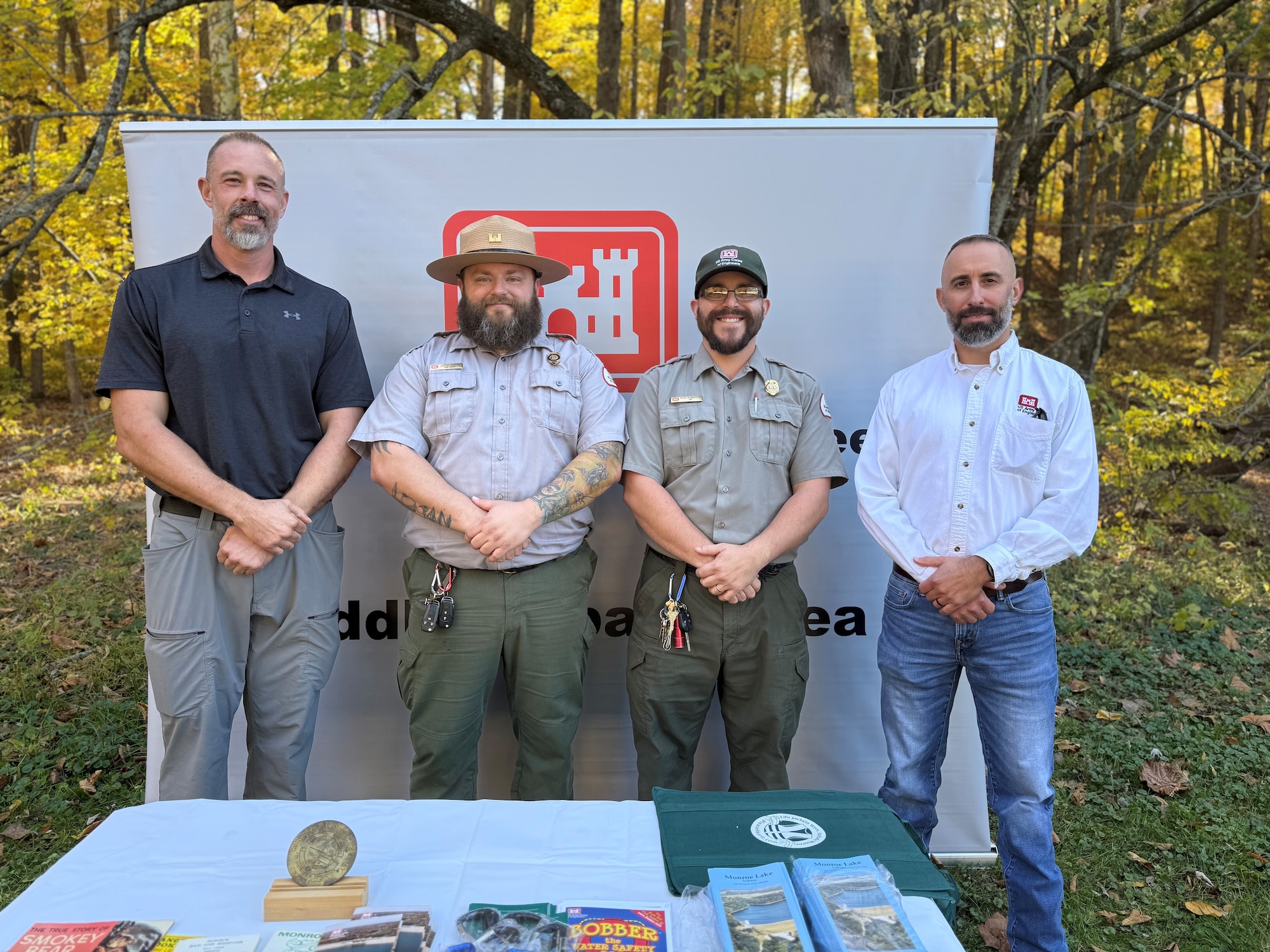 From left to right, Todd Eubank, Monroe Lake Natual Resources Project manager, Justin Burton, Tyler Blankenship, Park Rangers and Laban Lindley, Middle Wabash Area Operations manager, gather at the USACE display booth at the anniversary celebration Oct. 24 in Bloomington, Ind.