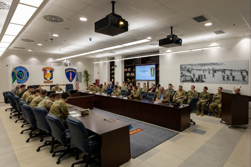 Service members sit at a table.