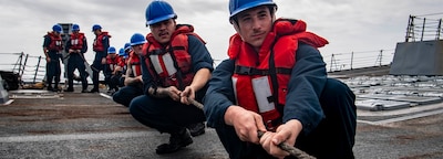 SOUTH CHINA SEA (Jan. 4, 2025) — Sailors heave the messenger line aboard the Arleigh Burke-class guided-missile destroyer USS Sterett (DDG 104) during a replenishment-at-sea with the Lewis and Clark-class dry cargo and ammunition ship USNS Richard E. Byrd (T-AKE 4), Jan. 4, 2025. The Carl Vinson Carrier Strike Group is underway conducting routine operations in the U.S. 7th Fleet area of operations. (U.S. Navy photo by Mass Communication Specialist 3rd Class Brianna Walker)