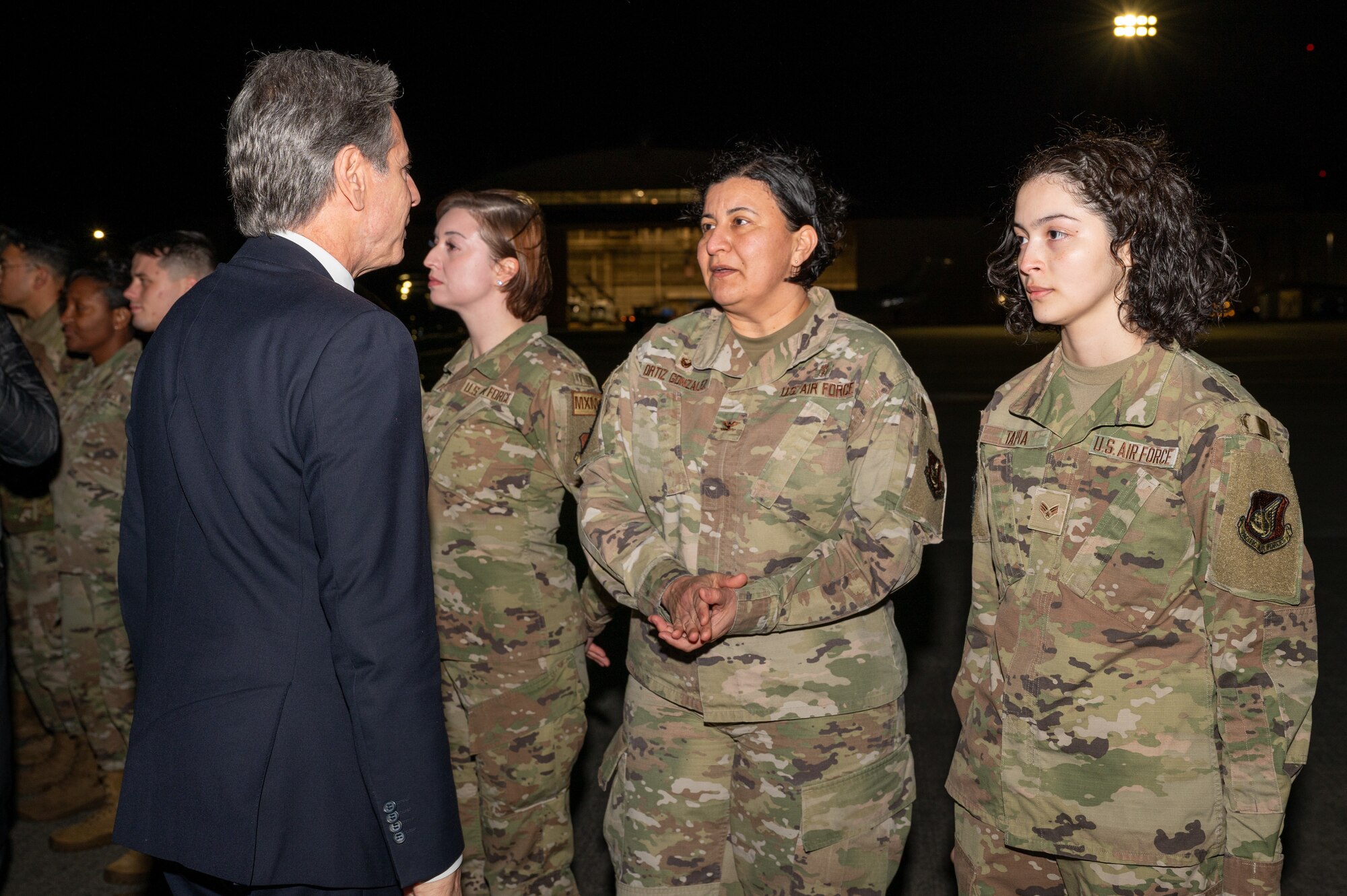 Secretary of State Antony Blinken listens to U.S. Air Force Lt. Col. Iris Ortiz Gonzalez, 374th Dental Squadron commander, as she introduces Senior Airman Arasely Tapia at Yokota Air Base, Japan.