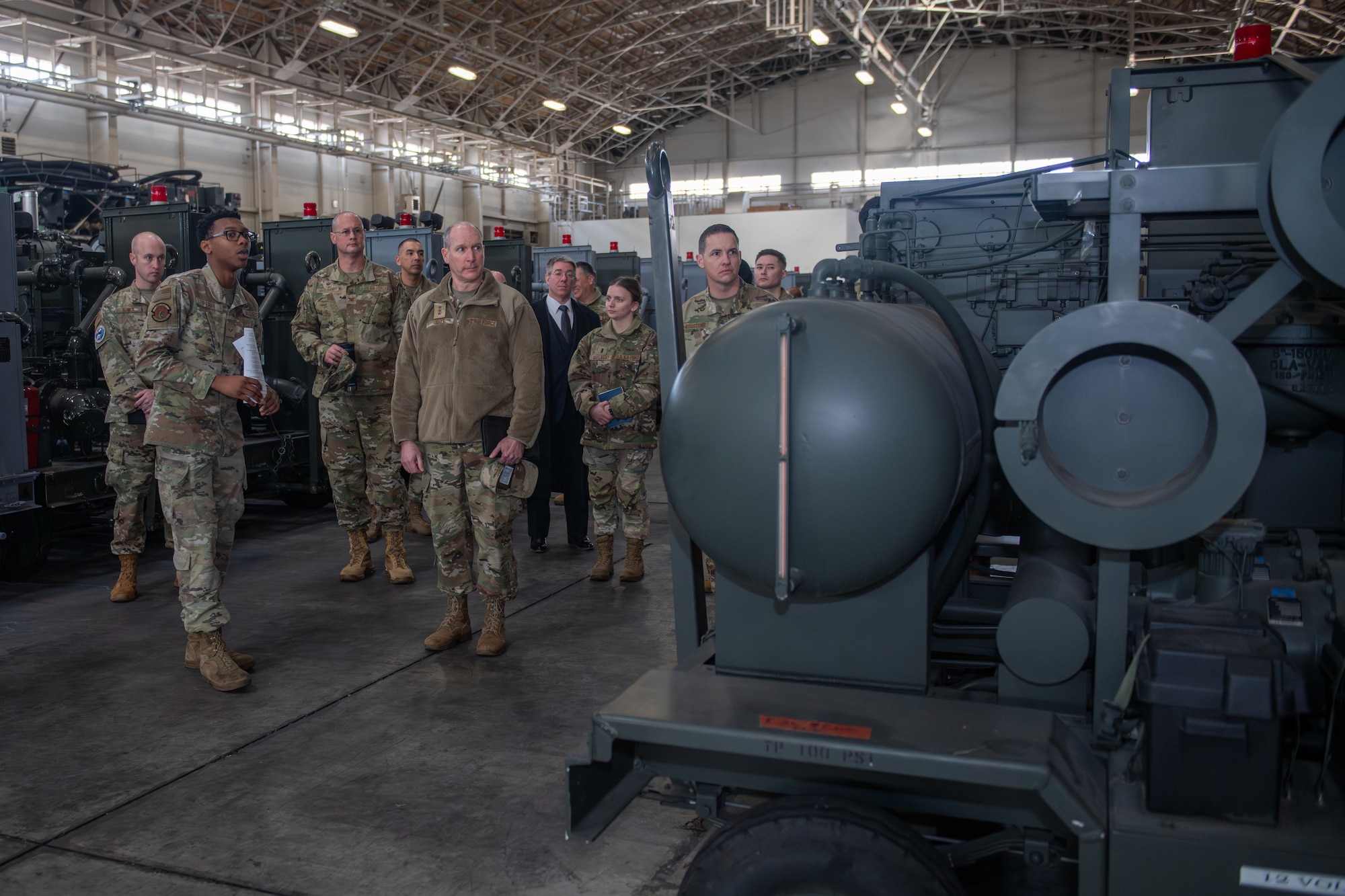 A group of Air Force personnel walk in a warehouse