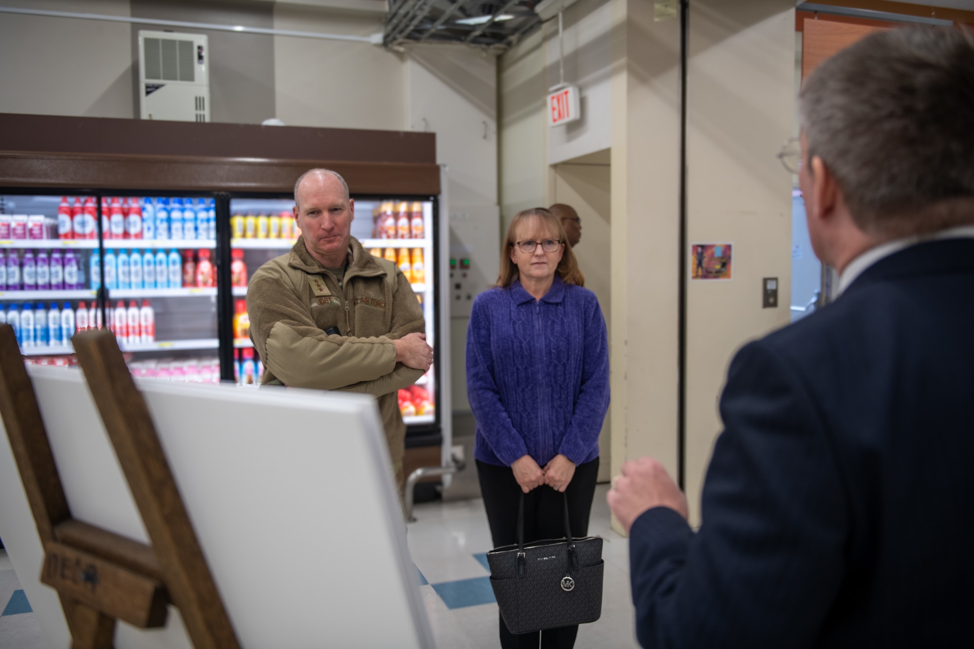 Lt. Gen. Jost and his wife look at a graph on a chart while standing in a supermarket