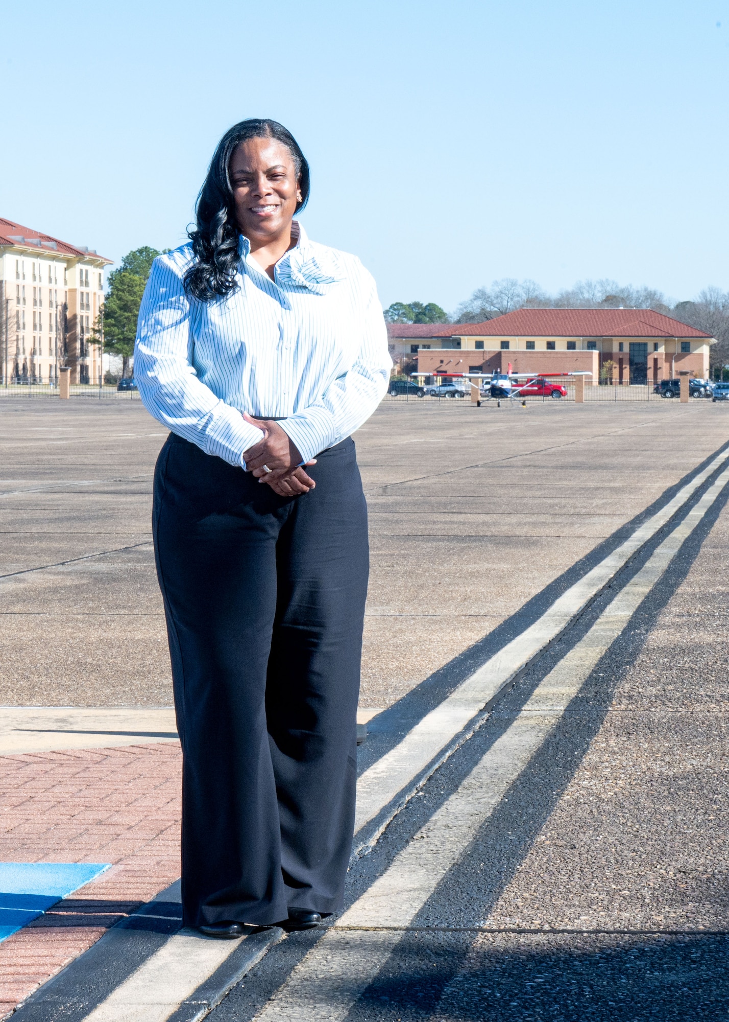 Contina Harmon, 42nd Operations Support Squadron airfield management specialist, poses for a photo on the flight line at Maxwell Air Force Base, Alabama, Jan. 2, 2025.