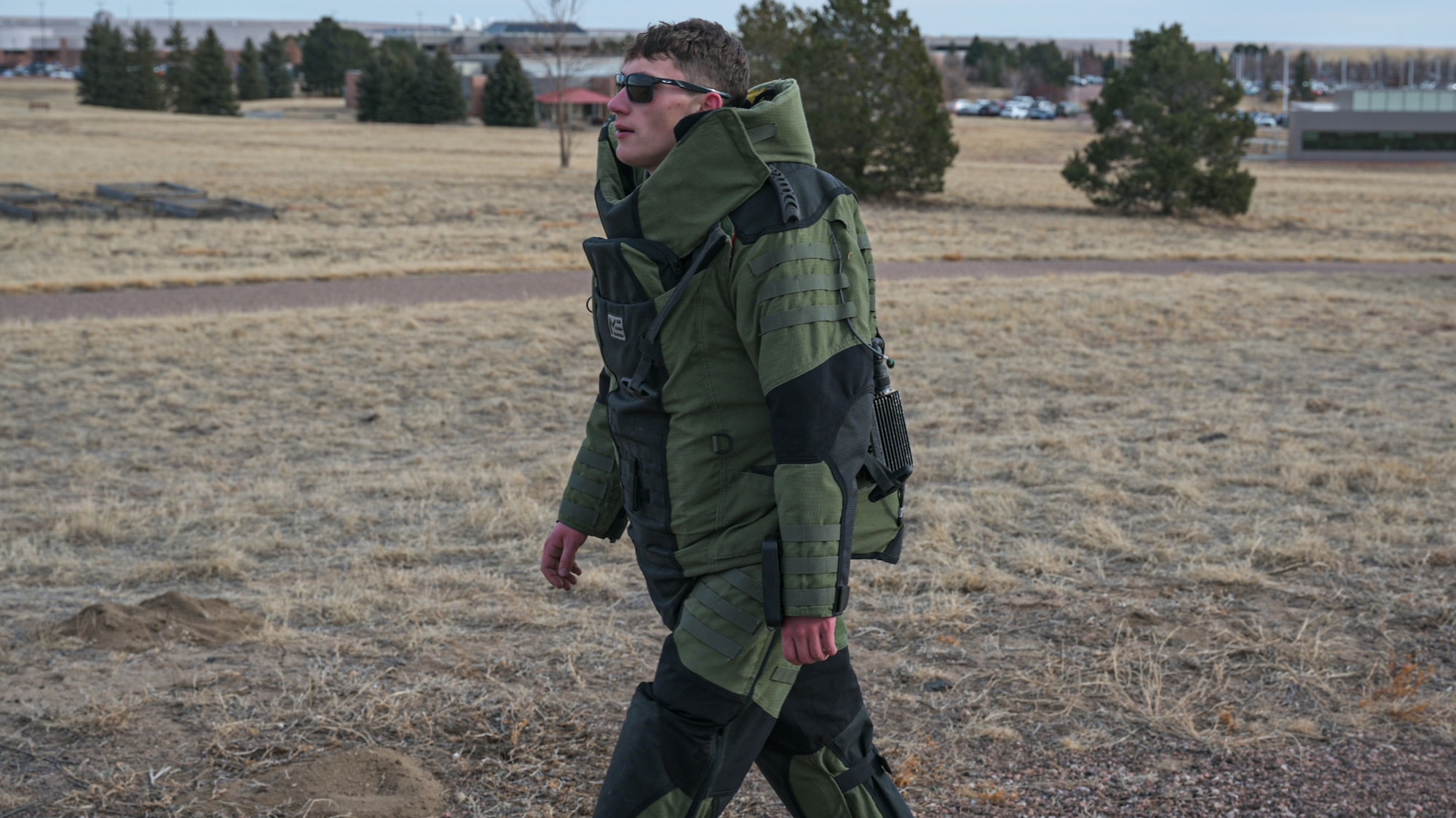 Airmen in EOD bomb suit rucks on Peterson Space Force Base.
