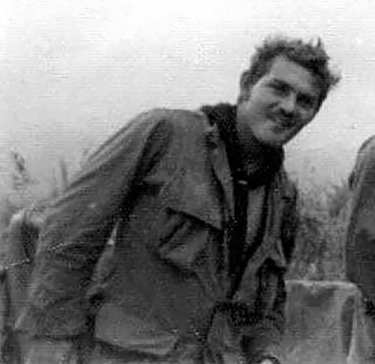 A man smiles at a camera.