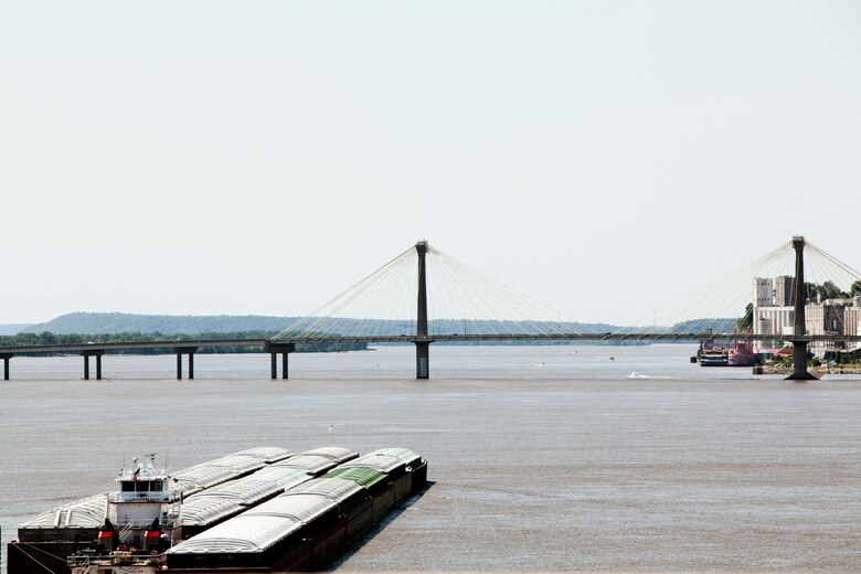 A tow pushing empty barges on the Mississippi River near Melvin Price Locks and Dam in Alton, Ill. transits upstream.