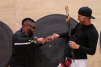 U.S Army Veteran, Staff Sgt. Bobby Green, of San Antonio, Texas, and U.S. Army Veteran, Sgt.  Robbie Gaupp, of Gatesville, Texas, remove the arrows from Gaupp's target during archery training for the Department of Defense Warrior Games