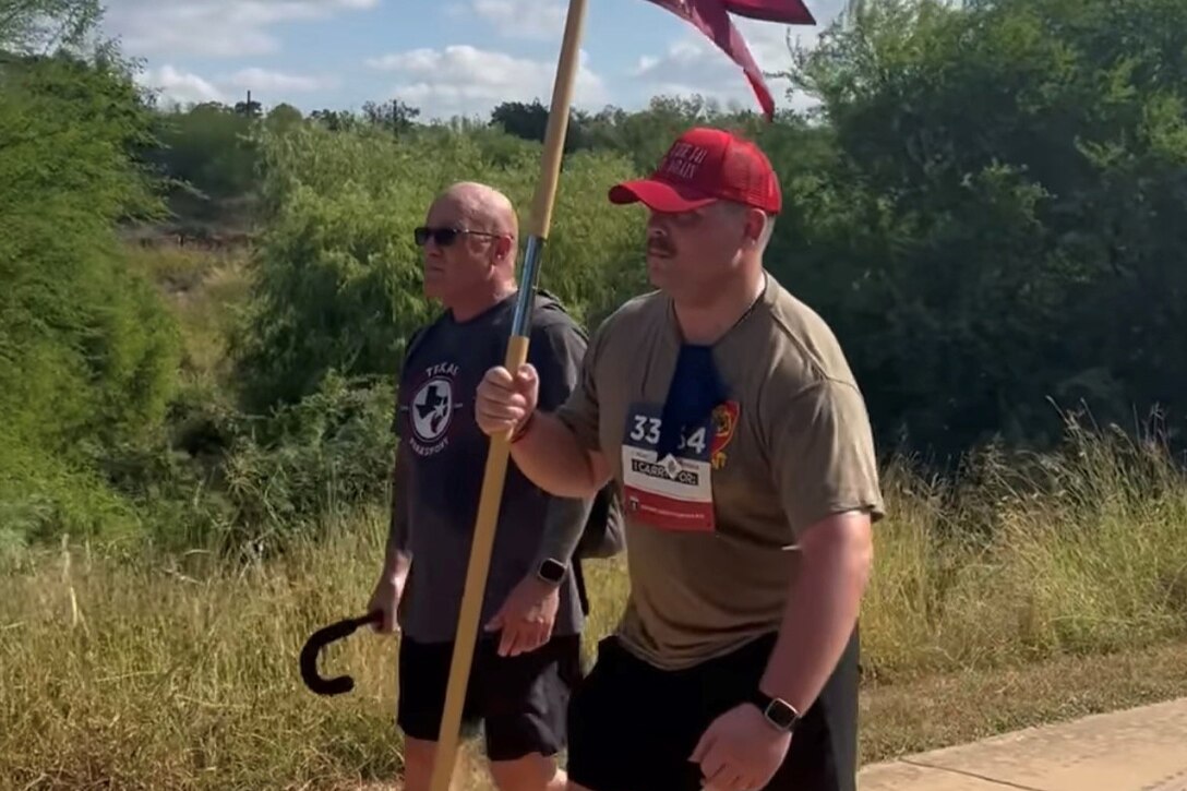 SSG Houston Taylor exchanged his cane with Maj. Ken LeBlanc for the SRU Guidon he carried across the finish line at a 5k in October 2024.