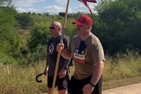 SSG Houston Taylor exchanged his cane with Maj. Ken LeBlanc for the SRU Guidon he carried across the finish line at a 5k in October 2024.