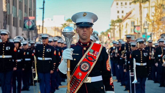 U.S. Marine Corps Gunnery Sgt. Weasley Hayes, drum major, Marine Band San Diego, leads the West Coast Composite Band in the 136th Rose Parade in Pasadena, California, Jan. 1, 2025. The Rose Parade, created to showcase the beauty of Pasadena, is part of an annual celebration, Tournament of Roses, that includes various floats, bands, dancers, and equestrian units. The Marine Corps has served the Nation honorably for 250 years. Marines embody the uncompromising standards and characteristics of honor, courage and commitment. (U.S. Marine Corps photo by Cpl. Alexandra M. Earl)