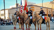 The U.S. Marine Corps' Mounted Color Guard carries the American Flag and the Marine Corps Standard in the 136th Rose Parade in Pasadena, California, Jan. 1, 2025. The Rose Parade, created to showcase the beauty of Pasadena, is part of an annual celebration, Tournament of Roses, that includes various floats, bands, dancers and equestrian units. The Marine Corps has served the Nation honorably for 250 years. Marines embody the uncompromising standards and characteristics of honor, courage and commitment. (U.S. Marine Corps photo by Cpl. Alexandra M. Earl)