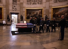 Service members in state funeral procession.