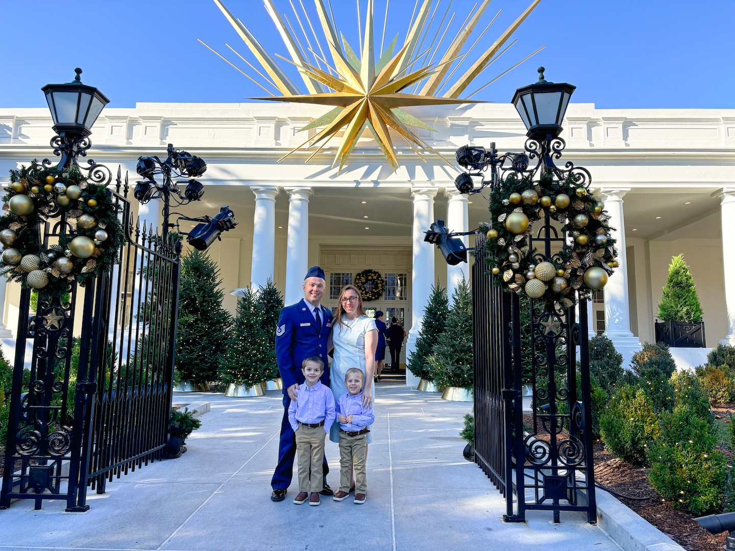 Photo of U.S. Air Force Tech. Sgt. Hayden Lessor, from the Low Observable Maintenance Shop, Vermont Air National Guard, standing for a photo with his family while attending the Joining Forces event at the White House in Washington, D.C.