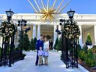 Photo of U.S. Air Force Tech. Sgt. Hayden Lessor, from the Low Observable Maintenance Shop, Vermont Air National Guard, standing for a photo with his family while attending the Joining Forces event at the White House in Washington, D.C.