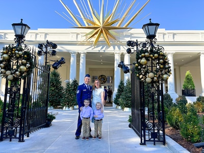 Photo of U.S. Air Force Tech. Sgt. Hayden Lessor, from the Low Observable Maintenance Shop, Vermont Air National Guard, standing for a photo with his family while attending the Joining Forces event at the White House in Washington, D.C.