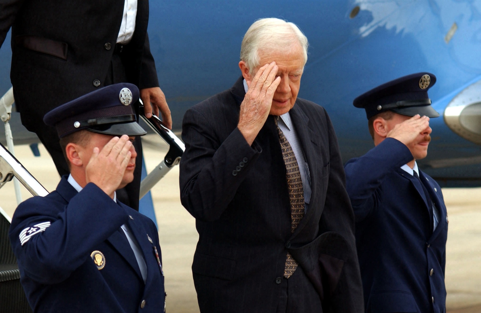 In the aftermath of the Sept. 11 terrorist attack, former President Jimmy Carter salutes as he arrives at Andrews Air Force Base, Maryland, on a C-20B Gulfstream, Sept. 14, 2001. Carter arrived to attend the National Prayer and Reconciliation Service at the National Cathedral in Washington. (DoD photo from RG 330 Office of the Secretary of Defense Combined Military Service Digital Photographic Files)