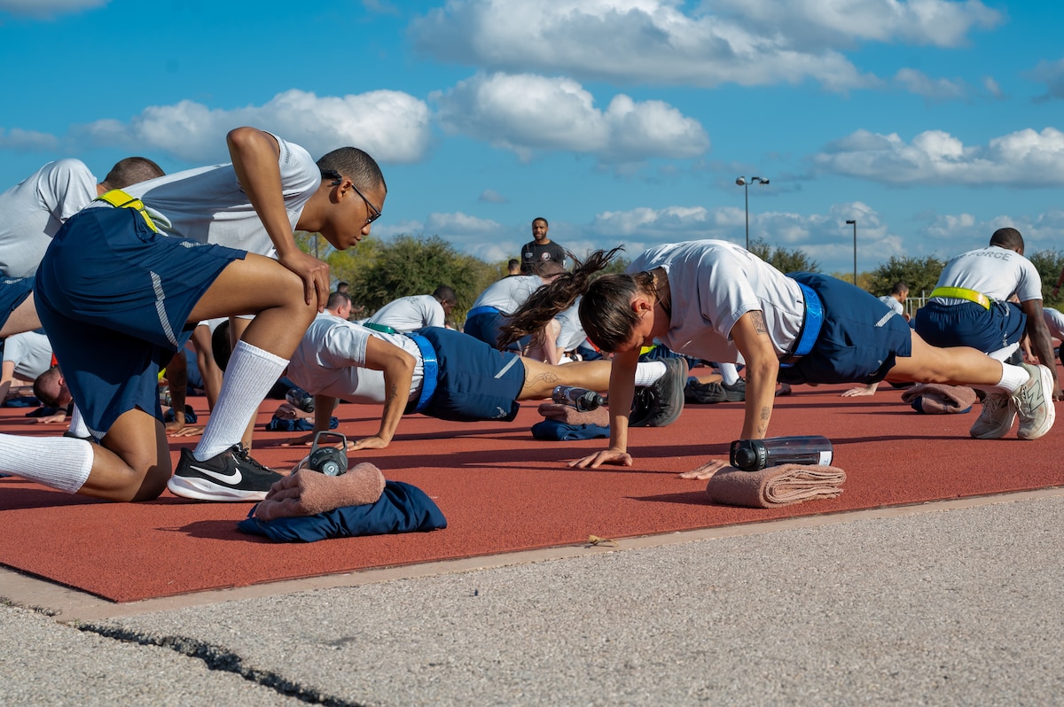 Trainee Anita Alvarez, 331st Training Squadron, completes the push up portion of her official physical fitness test during week five of Basic Military Training