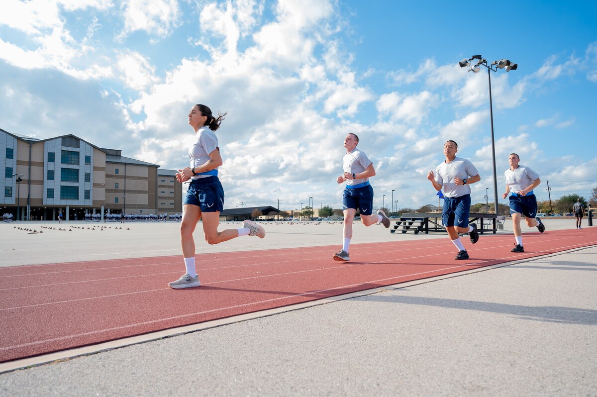 Trainee Anita Alvarez, 331st Training Squadron, leads from the front during the run portion of her official physical fitness test during week five of Basic Military Training