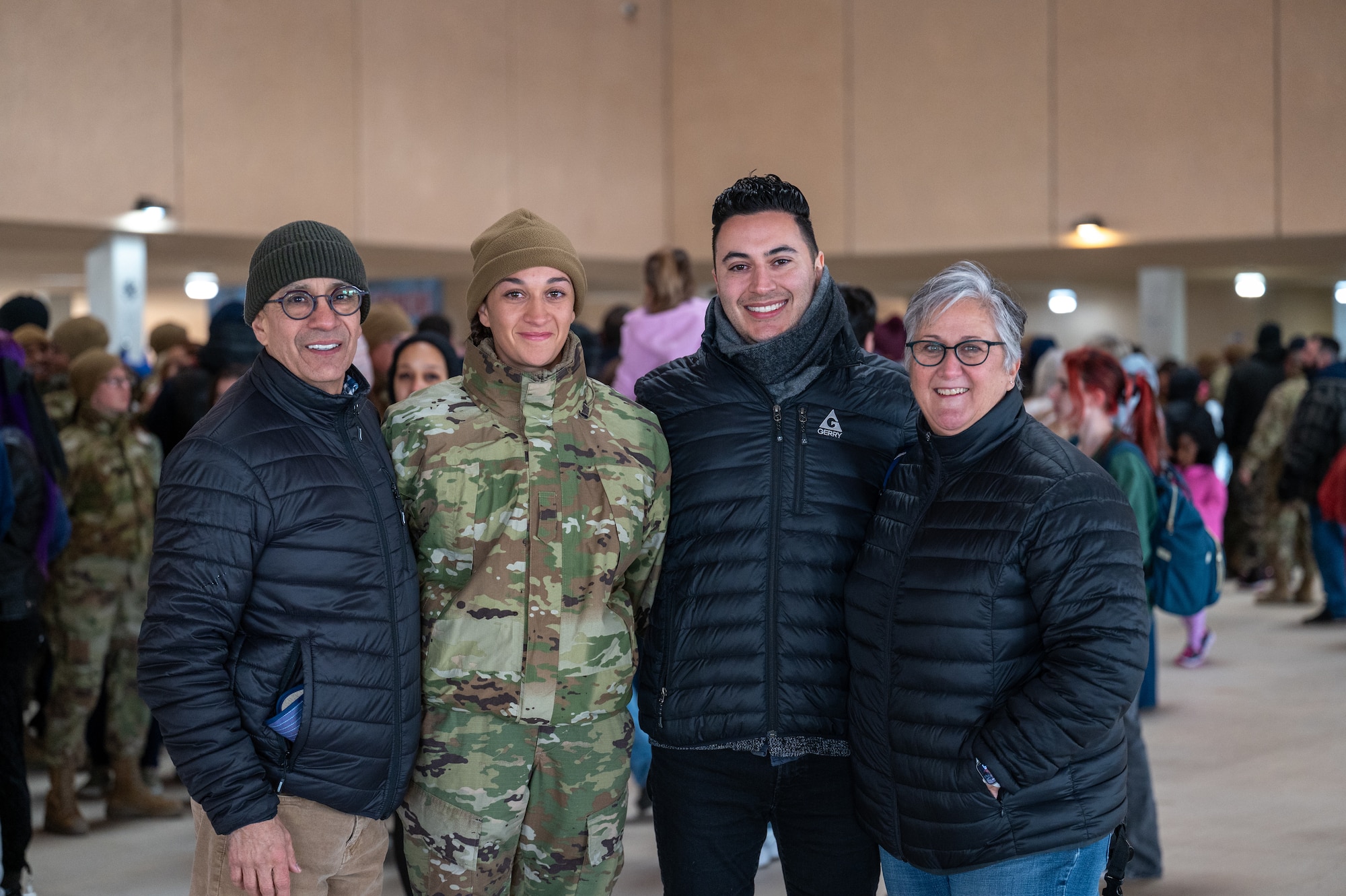Airman Anita Alvarez smiles with her family after the Basic Military Training Coin Ceremony