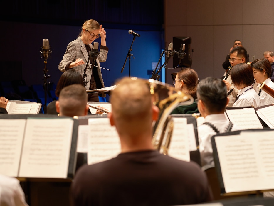 Lt. Andrea L. Sematoske, U.S. 7th Fleet Bandmaster, conducts a joint ensemble of U.S. 7th Fleet Band and Japan Maritime Self-Defense Force Yokosuka Band members at Commander, Fleet Activities Yokosuka, Japan's Benny Decker Theater before the team's  joint concert, Together For The Holidays, Sunday, December 15, 2024.