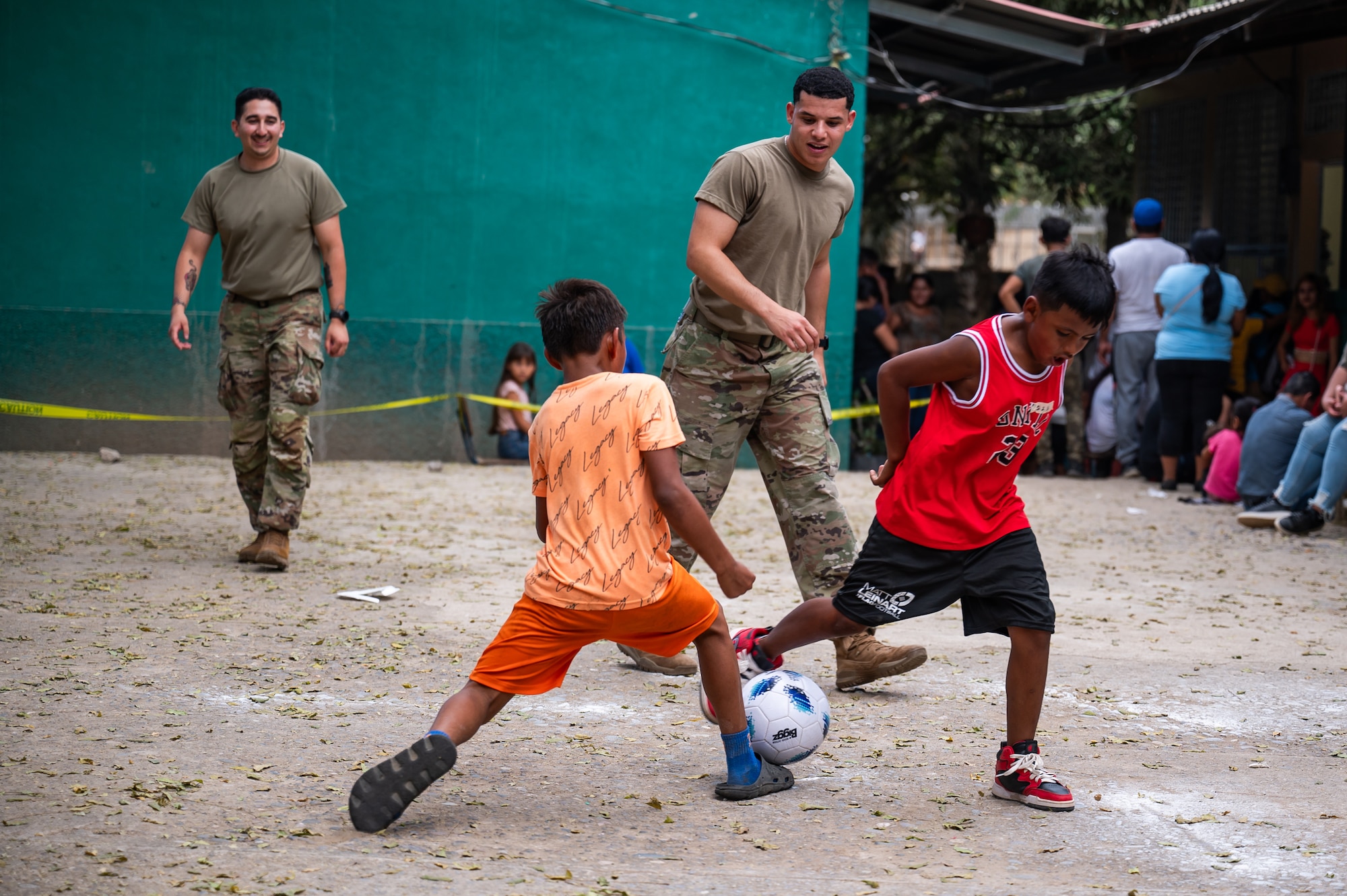 (Left) U.S. Army Sgt. Enoch Goncalez and (right) Spc. Jaden King, Joint Task Force-Bravo 349th Medical Detachment medics, play soccer with local children after a Medical Readiness Training Exercise in Choluteca, Honduras, January 8, 2025.