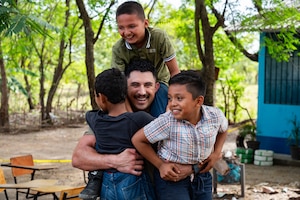 U.S. Army Sgt. Micol Bejar, Joint Task Force-Bravo 349th Medical Detachment medic, poses for a photo with local children during a Medical Readiness Training Exercise in Choluteca, Honduras, January 9, 2025.