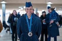 Airman Anita Alvarez poses for a photo with her 2024 Paris Olympics silver medal