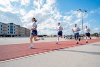 Trainee Anita Alvarez, 331st Training Squadron, leads from the front during the run portion of her official physical fitness test during week five of Basic Military Training