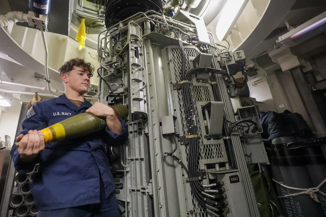 GMSN Daniel Martin moves ammunition aboard USS Princeton (CG 59) in the South China Sea.