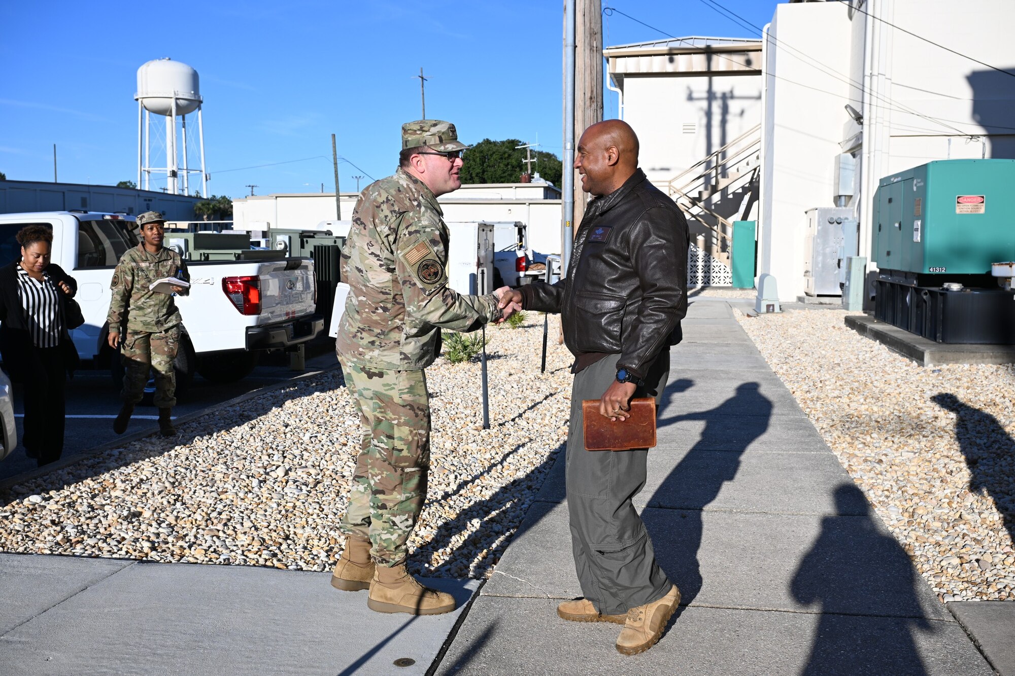 U.S. Air Force Col. Dustin Hart, left, Air Combat Command Public Affairs director, is greeted by U.S. Air Force Col. Larry Fenner Jr., 350th Spectrum Warfare Wing commander, during a visit to Eglin Air Force Base, Florida, Dec. 6, 2024. Hart and the leadership team visited all ACC public affairs offices along the panhandle to learn more about their respective missions and get to know personnel. (U.S. Air Force photo by Senior Airman Anna Smith)
