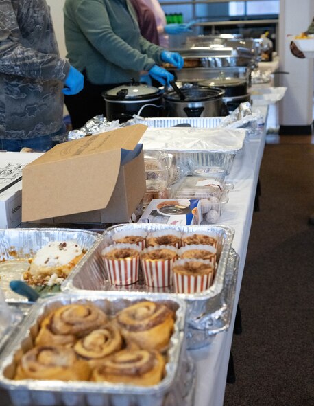 The Minot Spouses Club set up and provide food at a dorm dinner for Airmen at Minot Air Force Base, North Dakota, Jan. 8, 2025. The dorm dinner is an event put on by the Chaplain Corps and is facilitated by volunteer organizations and clubs every month for Airmen living in the dorms. (U.S. Air Force photo by Airman 1st Class Wesley Davies)