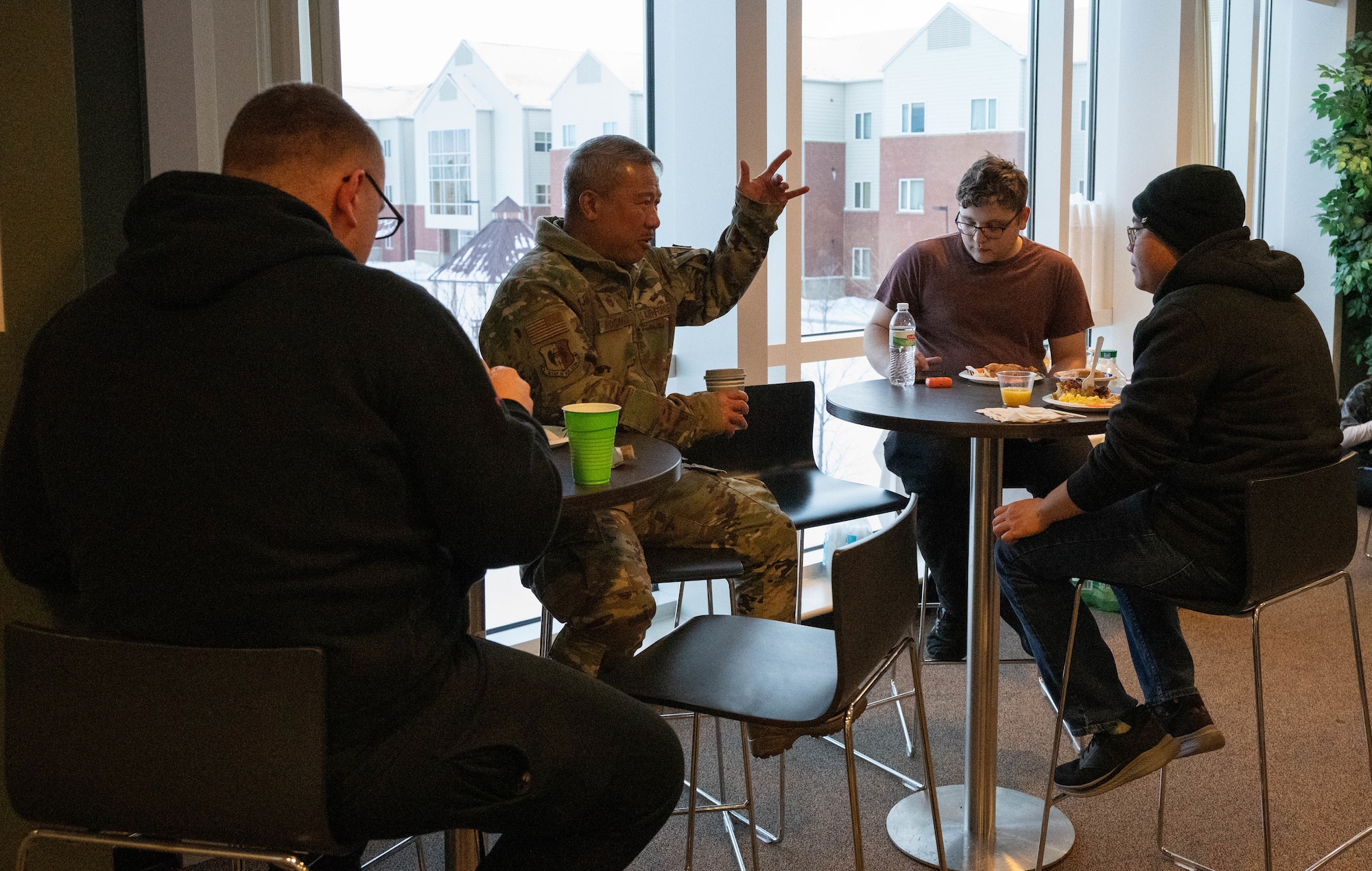 Airmen talk and eat with chaplains at the dorm dinner facilitated by the Minot Spouses Club at Minot Air Force Base, North Dakota, Jan. 8, 2025. The dorm dinner is hosted once every month and provides Airmen with an opportunity to build community and get a free dinner. (U.S. Air Force photo by Airman 1st Class Wesley Davies)