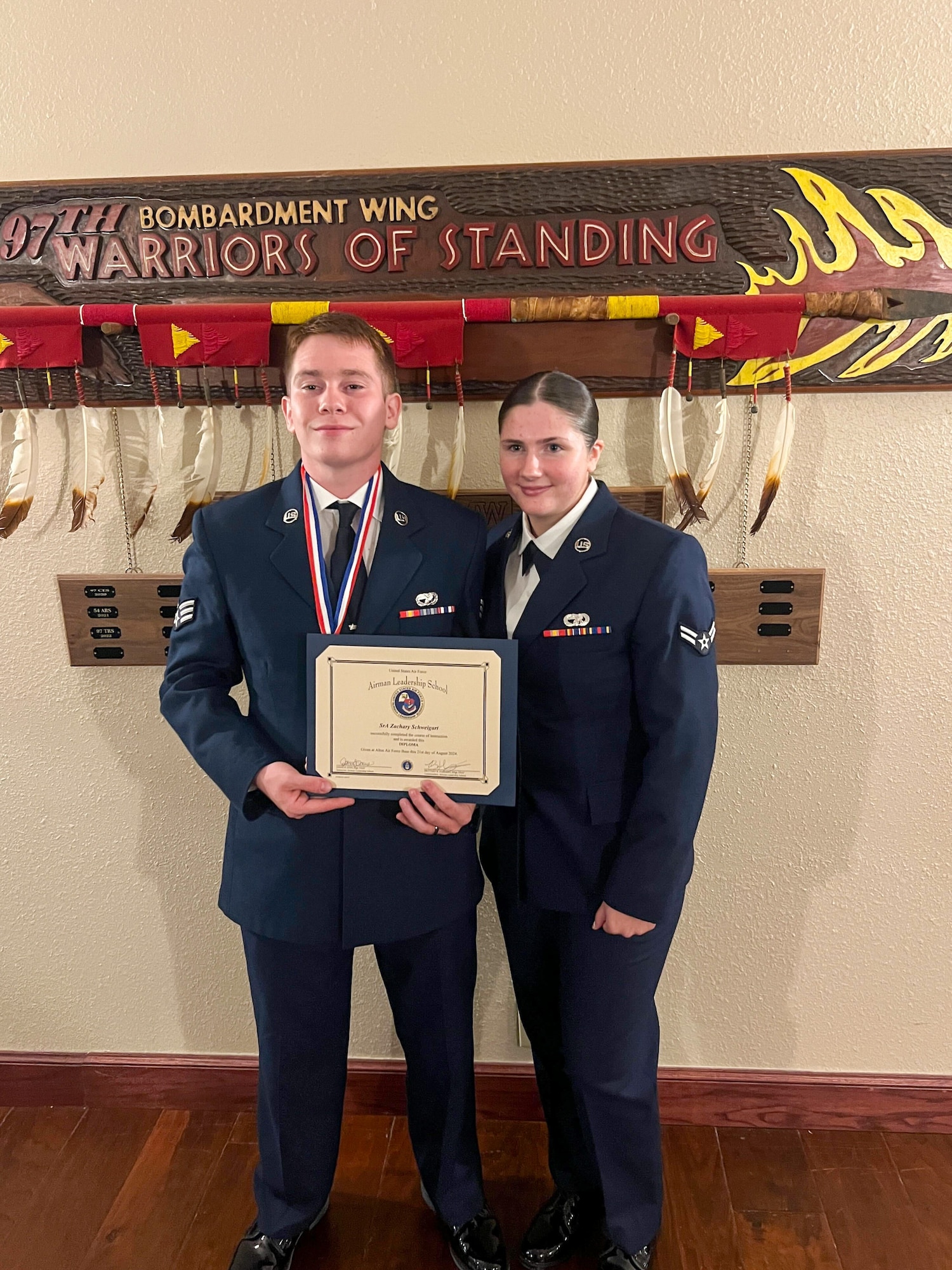 U.S. Air Force Senior Airman Zachary Schweigart, 97th Logistics Readiness Squadron (LRS) fire truck and refueling mechanic, and Airman 1st Class Ashlee Schweigart, 97th LRS vehicle mechanic, pose for a photo at Club Altus at Altus Air Force Base, Oklahoma. This photo was taken shortly after Schweigart’s Airman Leadership School graduation. (Courtesy photo)