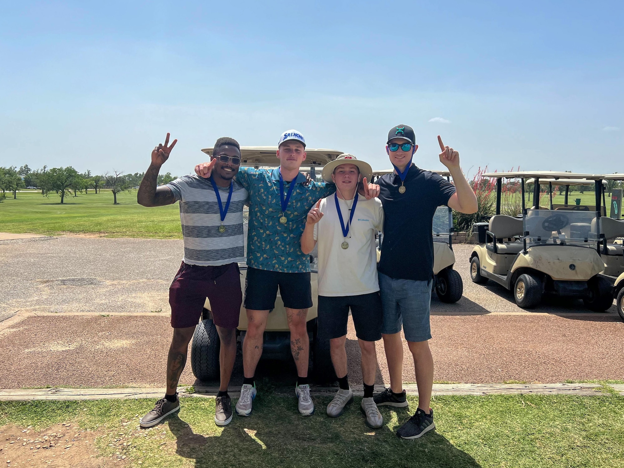 U.S. Air Force Senior Airman Zachary Schweigart, 97th Logistics Readiness Squadron fire truck and refueling mechanic, poses with fellow Airmen at the Windy Trails Golf Course at Altus Air Force Base, Oklahoma. Schweigart said maintaining a good relationship with co-workers can help with motivation in the workplace. (Courtesy photo)