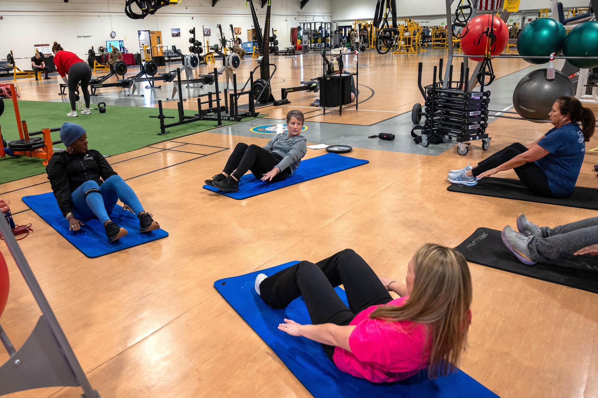 Kim Lissner , 87th Force Support Squadron fitness and sports specialist, at top center, leads students in a  workout class at the Griffith Field House, Joint Base McGuire-Dix-Lakehurst, N.J., Jan. 7, 2025. Military and civilian personnel at JB MDL kicked off 2025 by strengthening their fitness, united in the mission to get fit for the fight. (U.S. Air Force photo by Susan Moriarty)