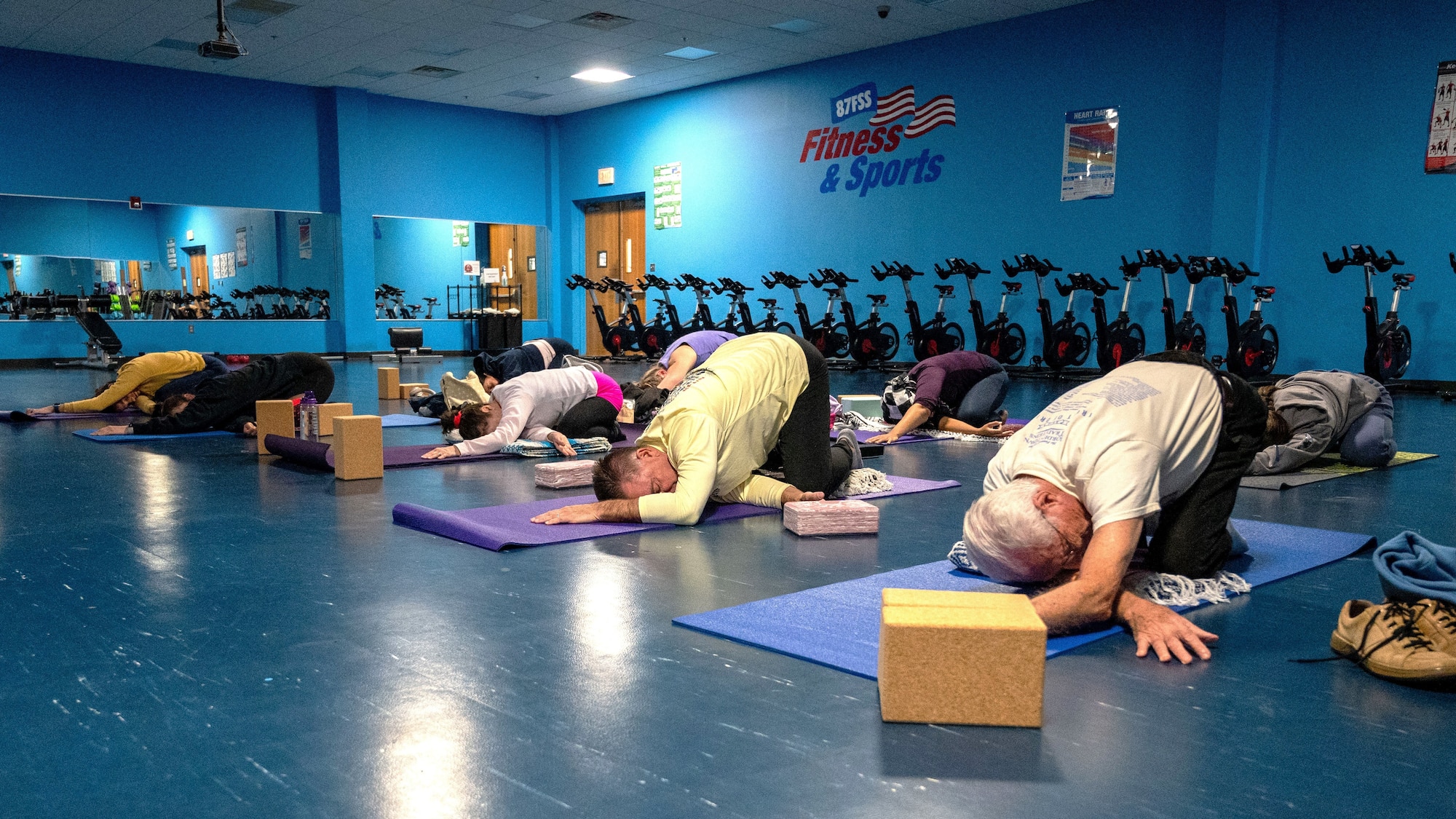 Students hold a twisted child’s pose during a yin yoga class at the McGuire Fitness Center, Joint Base McGuire-Dix-Lakehurst, N.J., Jan. 8, 2025. Military and civilian personnel at JB MDL kicked off 2025 by strengthening their fitness, united in the mission to get fit for the fight. (U.S. Air Force photo by Susan Moriarty)