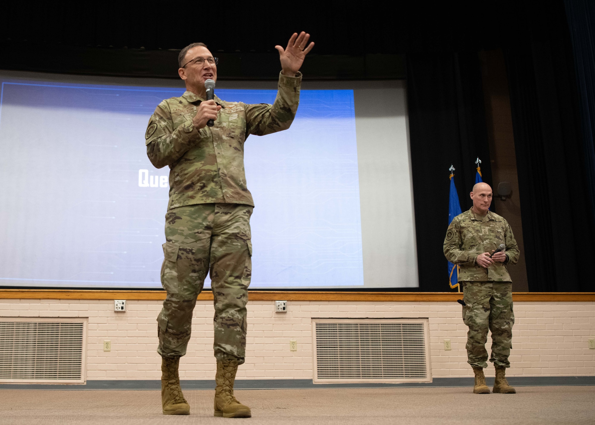 a man in a military uniform gives a presentation to a military audience.