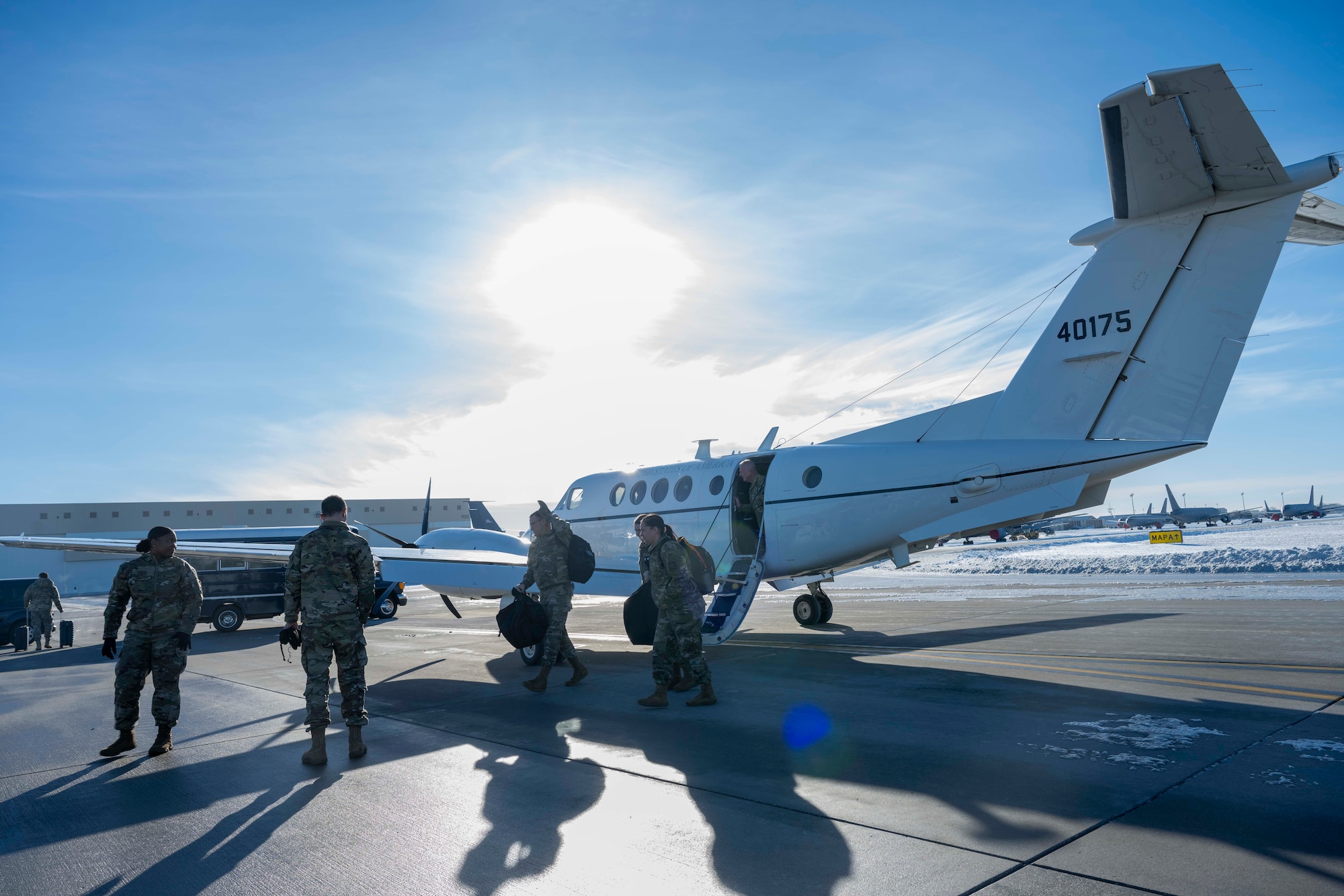 The Team McConnell command team greets the Air Mobility Command team at McConnell Air Force Base, Kansas, Jan. 7, 2025. The AMC party included Gen. John Lamontagne, AMC commander, and Chief Master Sgt. Jamie Newman, AMC command chief. (U.S. Air Force photo by Airman 1st Class Paula Arce)