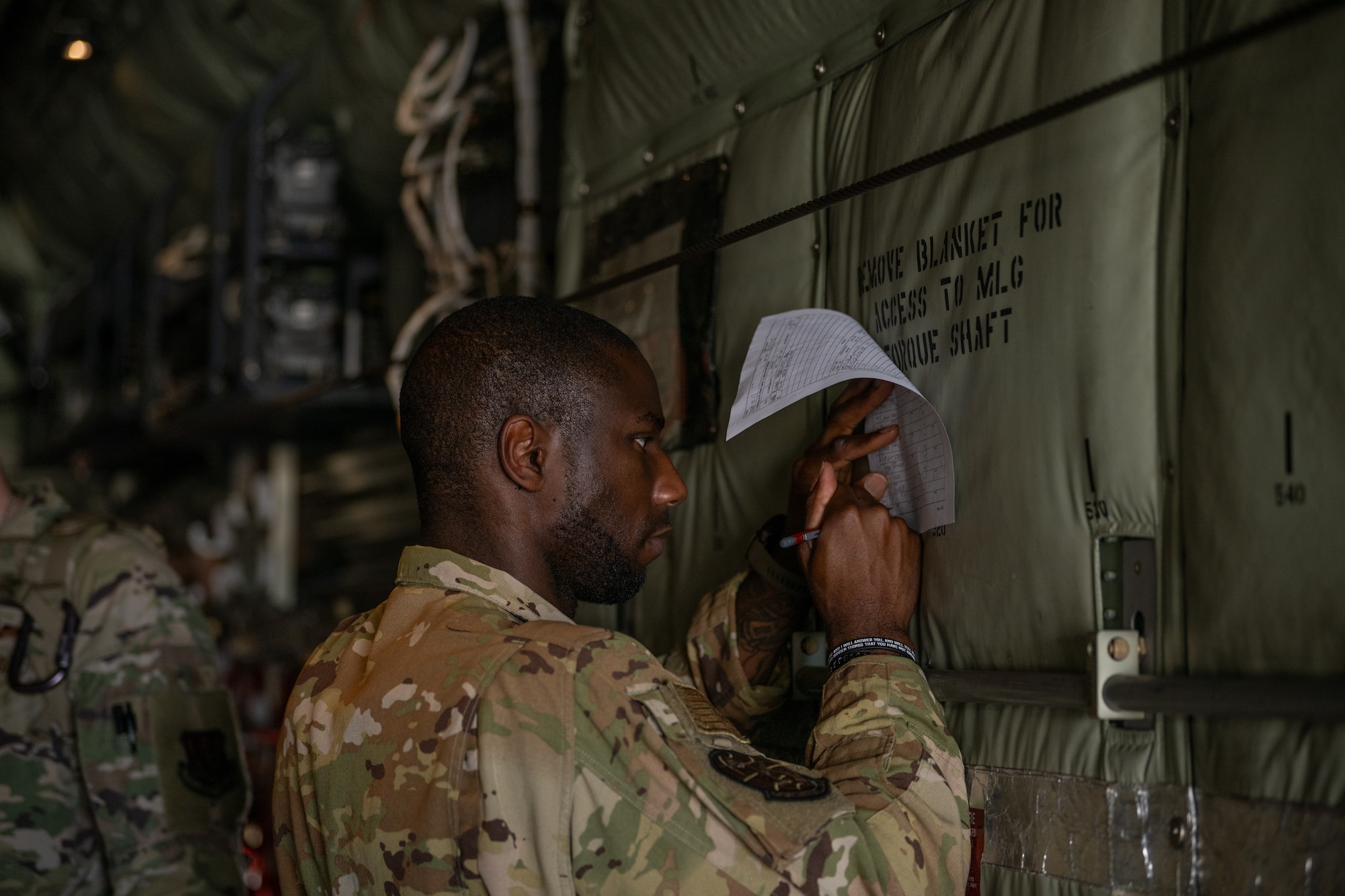 Airman writes rigging log.