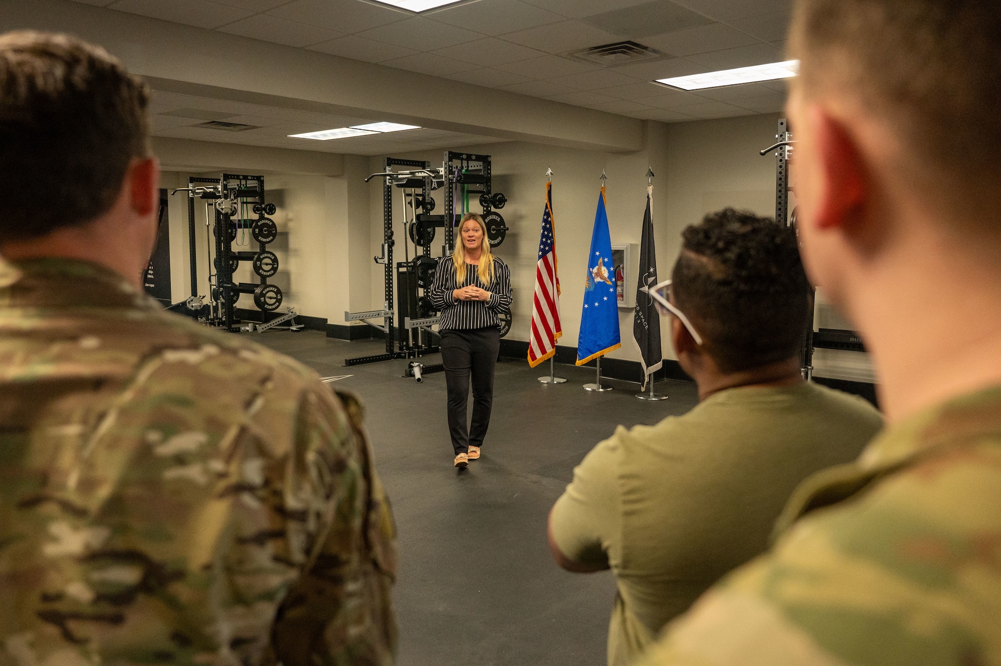 Megan Brunelle, Space Launch Delta 45 Guardian Resiliency Team physical therapist, addresses attendees during the ribbon cutting ceremony unveiling the Fitness Center’s recently renovated training room at Patrick Space Force Base, Florida, Jan. 10, 2025. The SLD 45 GRT team funded renovations for this training room to enhance physical fitness resources, promoting well-being and operational mission readiness of Guradians.