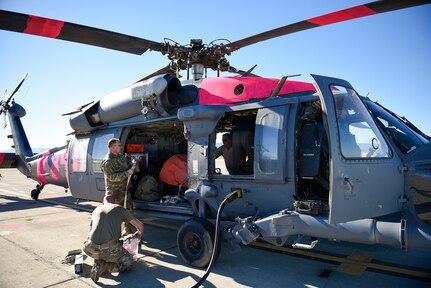 U.S. Air Force Airmen with the 129th Rescue Wing, California Air National Guard, at Moffett Air National Guard Base, Calif., load equipment onto an HH-60G Pave Hawk helicopter to support the Palisades Fire Jan. 9, 2025.  The unit is activated by Calif. Governor Gavin Newsom to assist with firefighting in the Los Angeles area.