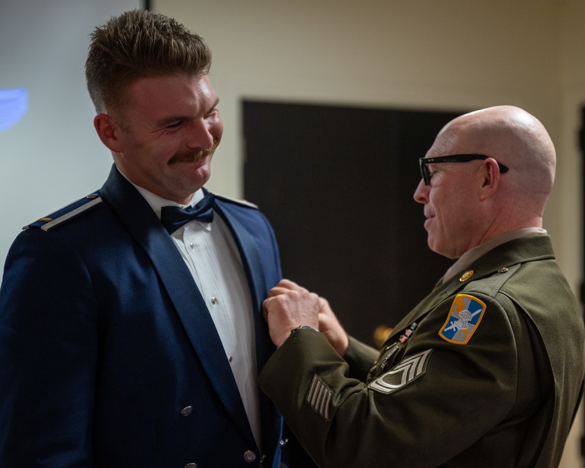 A U.S. Army Sgt. 1st Class pins the wings on a recently graduated pilot at Laughlin Air Force Base, Texas, Jan. 9, 2025. Pilot wings are a symbol of the proficiency achieved during training, going back to the first aviators to be awarded them, Capt. Charles de F. Chandler and Lt. Thomas DeWitt Milling. (U.S. Air Force photo by Staff Sgt. Nicholas Larsen)