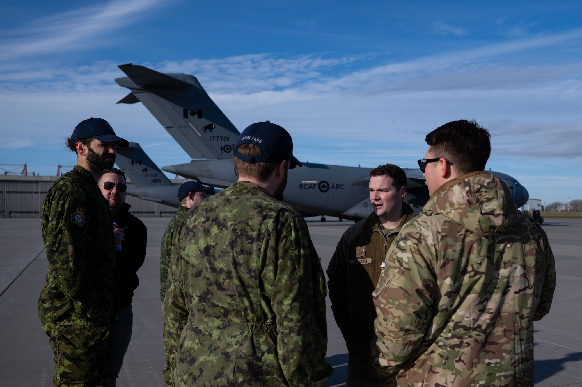 U.S. Air Force Airmen assigned to the 305th Air Mobility Wing discuss KC-46A Pegasus aircraft capabilities with Royal Canadian Air Force members during a joint training exercise at Canadian Forces base Trenton, Ontario, Nov. 15, 2024. Operation Crimson Snowman focused on the capabilities of the KC-46 Pegasus aircraft, with a significant emphasis on aerial refueling—a critical specialty the RCAF is poised to adopt and begin operations in 2027. (U.S. Air Force photo by Tech. Sgt. Monica Roybal)