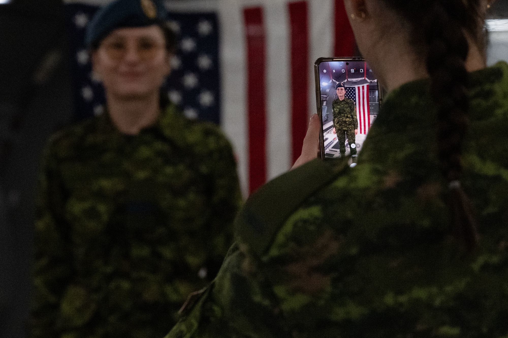 Royal Canadian Air Force Aviator Ava Green, 24 Canadian Forces Health Services pharmacy technician, takes a photo of Capt. Iryna Zhyrnova, 24 CF pharmacist, during a joint training exercise at Canadian Forces base Trenton, Ontario, Nov. 15, 2024. The 2nd Air Refueling Squadron staged two KC-46A Pegasus aircraft at Canadian Forces base Trenton, Ontario, and hosted Canadian Forces members during mission orientation opportunities. (U.S. Air Force photo by Tech. Sgt. Monica Roybal)