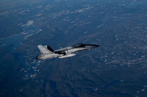 A Royal Canadian Air Force CF-18 Hornet aircraft assigned to 3 Wing Bagotville participates in the joint training exercise Operation Crimson Snowman over Saguenay-Lac-Saint-Jean, Quebec, Nov. 14, 2024. The joint training focused on the capabilities of the KC-46 Pegasus aircraft, with a significant emphasis on aerial refueling—a critical specialty the RCAF is poised to adopt and begin operations in 2027. (U.S. Air Force photo by Tech. Sgt. Monica Roybal)