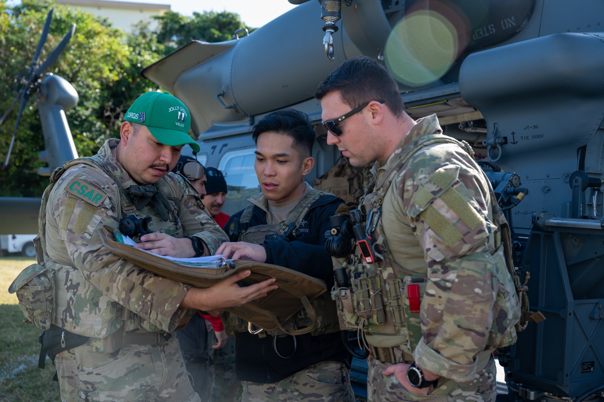 Airmen huddle together to review a checklist.