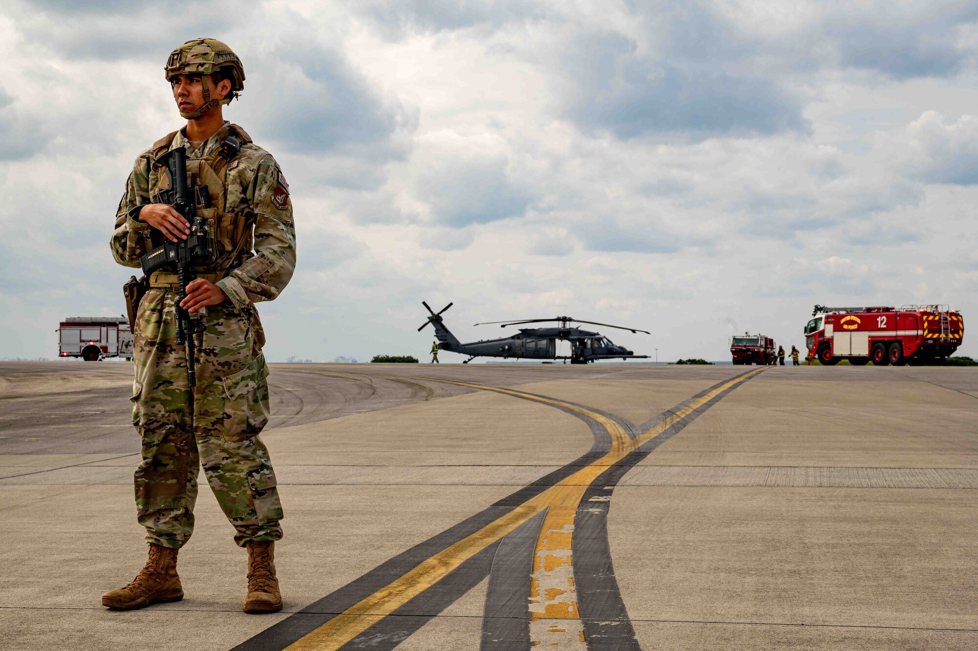 An Airman stands guard on the perimeter of a simulated aircraft wreck.